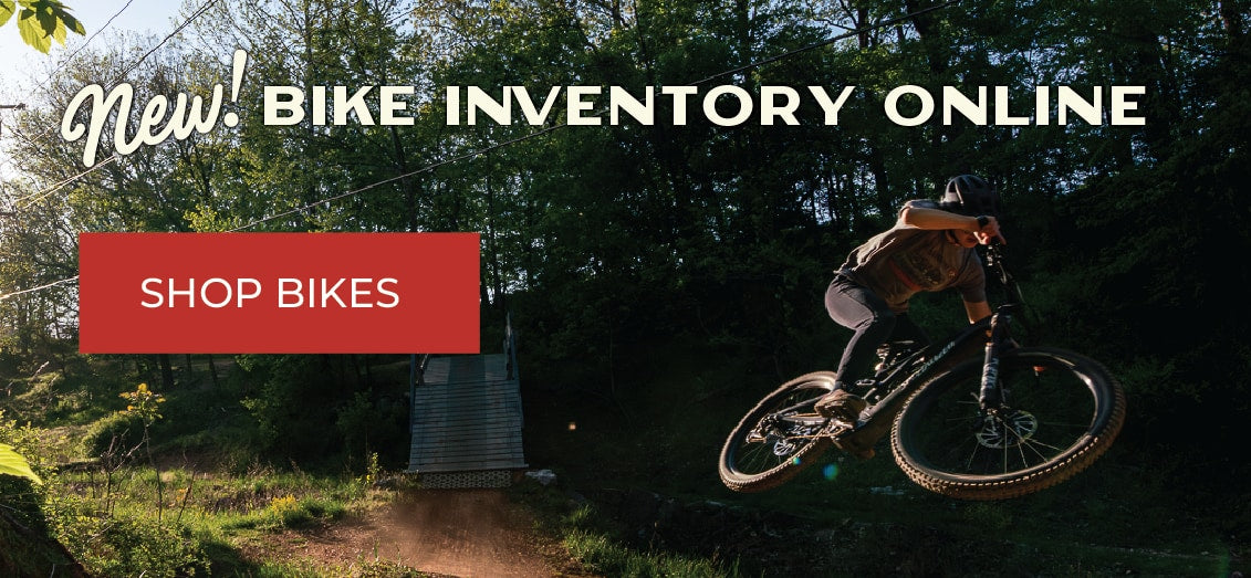 Banner image that links to Bike Shop with bicyclist jumping on trail